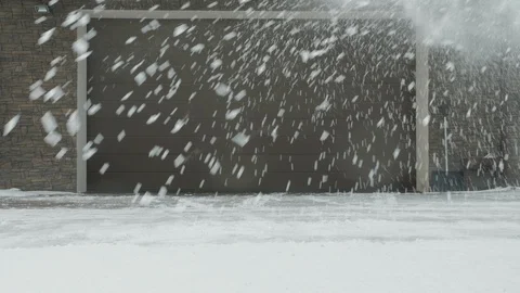 Man cleans snow with a snow thrower right to left Stock Footage 125821475