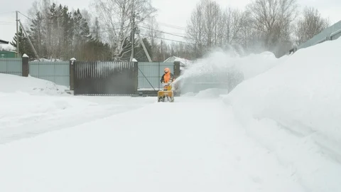 Man cleans snow with a snow thrower Stockbeeldmateriaal 125822928