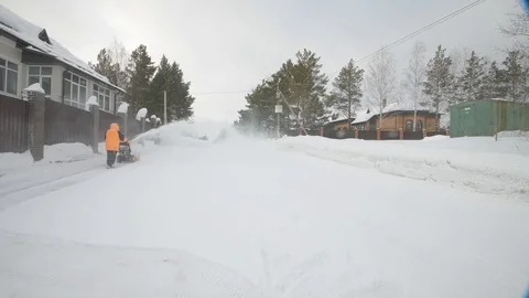 Man cleans snow with a snow thrower Stock Footage 125823832