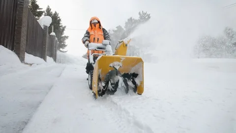 Man cleans snow with a snow thrower. Close up Stock Footage 125824104