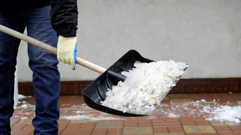 Man cleans snow from the yard Stock Photos