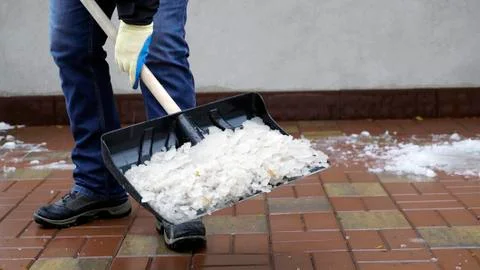 Man cleans snow from the yard Stock Photos