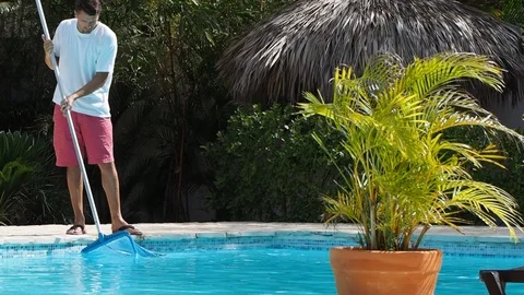 Man cleans the swimming pool. Stock Footage 111539122