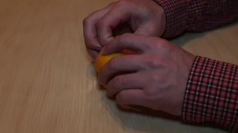 Man cleans tangerine Stock Footage 59785235