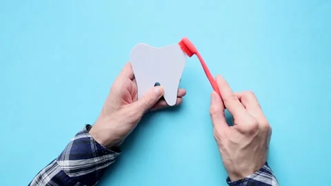 Man cleans tooth model with toothbrush. Concept against caries. Dental care. Stock Footage 190430510
