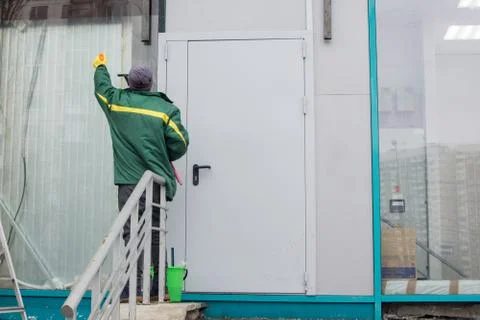 Man cleans the window Stock Photos