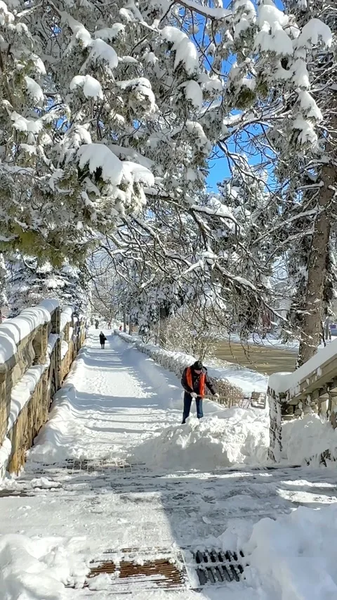 Man clear snow from sidewalk, cleans footpath from snow during blizzard.  Stock Footage 232673893