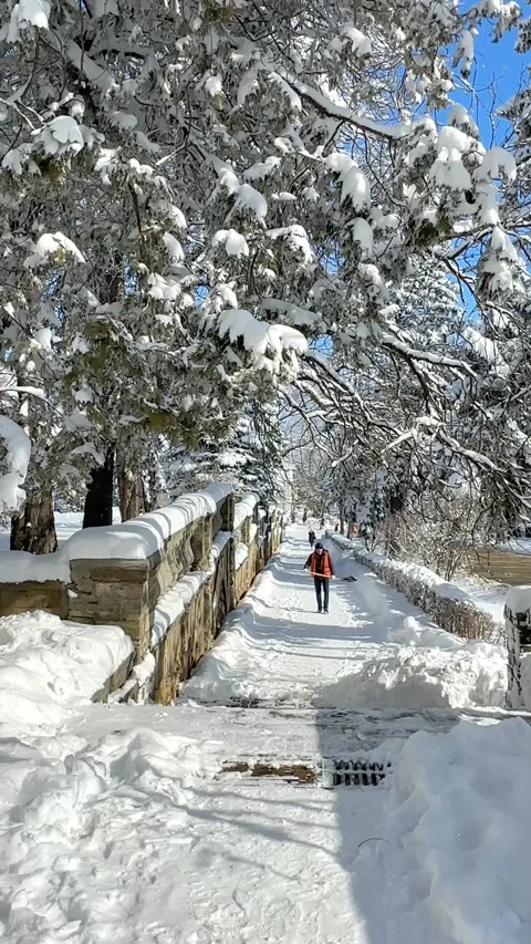 Man clear snow from sidewalk, cleans footpath from snow during blizzard.  Stock Footage 232673895