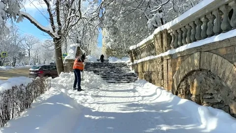 Man clear snow from sidewalk, cleans footpath from snow during blizzard.  Stock Footage 232673904