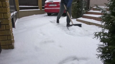 Man Clearing Backyard Pavement of Snow with Snowshovel Time Lapse Stock Footage 147083876