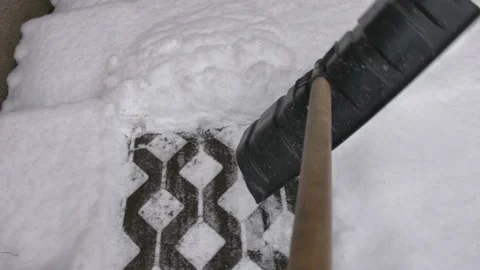 Man Clearing Backyard Pavement of Snow with Snowshovel Stock Footage 147083994