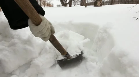 Man clearing deep snow off with shovel - garden snowdrift Stock Footage 10889464