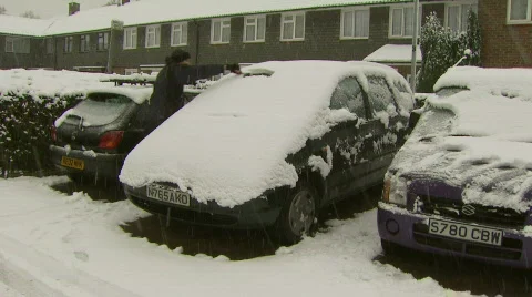 Man clearing snow from car Stock Footage 503464