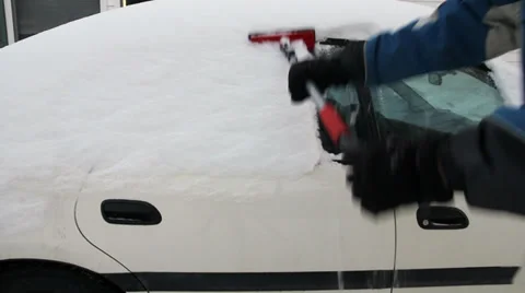 Man clearing snow from car windows Stock Footage 33603769
