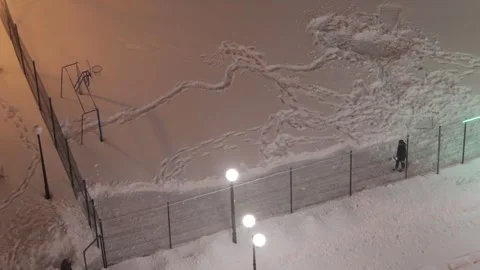 Man clearing snow from skating rink Stock Footage 287600943