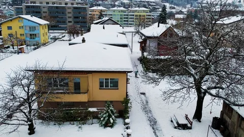 Man clearing the snow in the streets of small town in Switzerland during winter Stock Footage 123882451