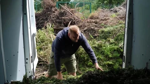 Man Clearing Van Full of Garden Weeds at Recycling Trip Site 스톡 동영상 339159061