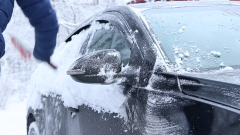 A man clears the car of snow . Much snow. Snow covered the cars. Stock Footage 106651200