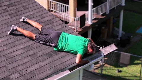 Man Clears Clogged Gutter Downspout   Stock Footage 345600000