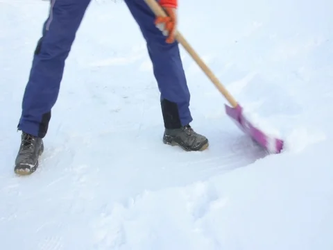A man clears snow with a shovel. winter.   close up Stock Footage 85001209