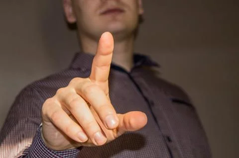 Man click on the virtual touch screen, finger is lifted up, futuristic business Stock Photos