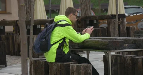 Man Clicks Tablet in Cafe Outdoors Shopping Texting Chatting Via Messenger Real Stock Footage 62186351