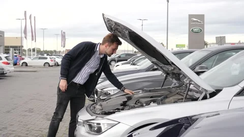 A Man Client check an Engine of a BMW Car on an Exhibition Stock Footage 140937280