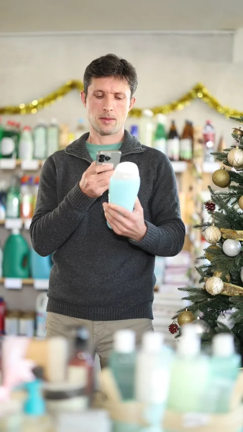 Man client choose and scanning QR code on package shampoo or shower gel Stock Footage 318430571