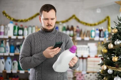Man client, by scanning QR code, gain access to information about liquid washing Stock Photos