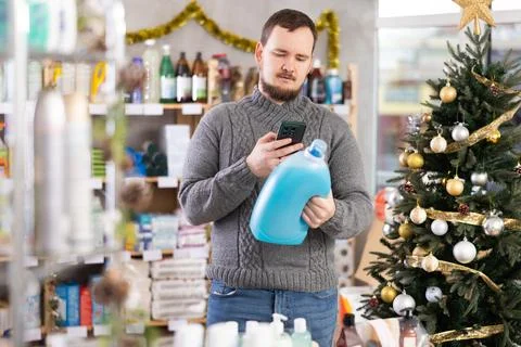 Man client, by scanning QR code, gain access to information about liquid washing Stock Photos