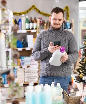 Man client, by scanning QR code, gain access to information about liquid washing Stock Photos
