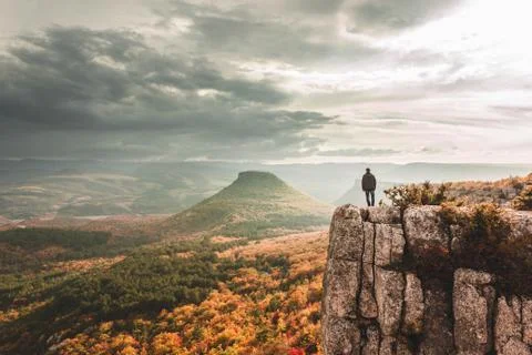 Man on the cliff edge Stock Photos