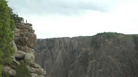 Man on cliff ledge Stock Footage 26078623