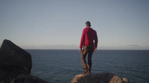 Man on the Cliff Looking at Sea Stock Footage 264055926