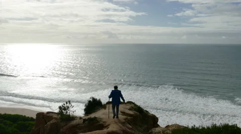 Man Climb on a Cliff Above the Ocean Stock Footage 46507833