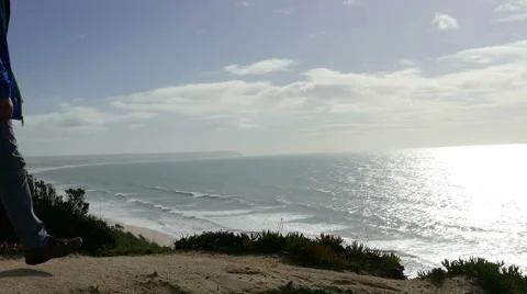 Man Climb on a Cliff Above the Ocean Stock Footage 46510053