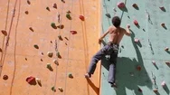 Man Climber Is Climbing On The Outdoors Climbing Gym Stock Footage