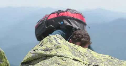 A man-climber reaches the top by doing his best. Stock Footage 247662793