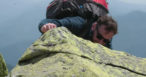 A man-climber reaches the top by doing his best. Stock Footage 247662928