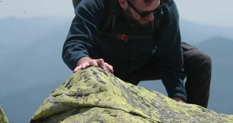 A man-climber reaches the top by doing his best. Stock Footage 247662936