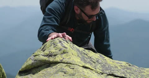 A man-climber reaches the top by doing his best. Stock Footage 247663025