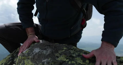 A man-climber reaches the top by doing his best. Stock Footage 247663128