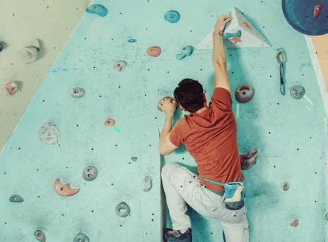 Man climbing artificial boulder Stock Photos