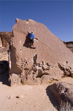 Man climbing boulder Stock Photos