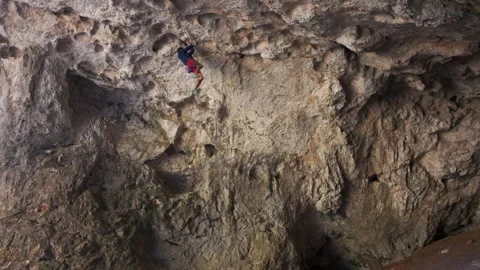 Man Climbing Up Cliff. 4K Stock Footage 266918131