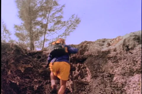 Man climbing cliff. Stock Footage 974066