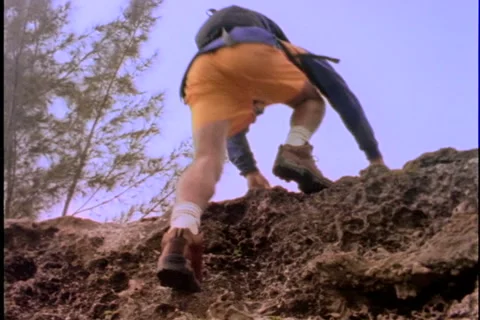 Man climbing a cliff. Stock Footage 974067