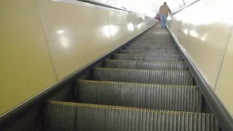 A man is climbing an escalator in the subway 스톡 동영상 98217056