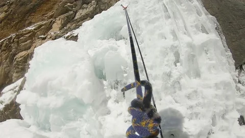 Man climbing ice waterfall with rope and ice axe Stock-Footage 170980958