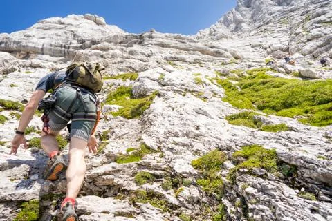 Man climbing mountain Stock Photos
